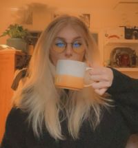 Photo of Ava Swanson holding coffee mug
